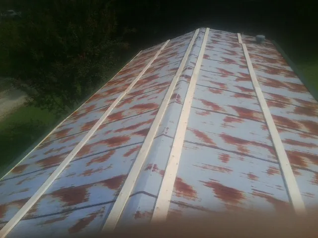 Rusted metal roof panels with new wood purlins before replacement — Storm Damage Roof Repair in Refton by Roofing Brothers