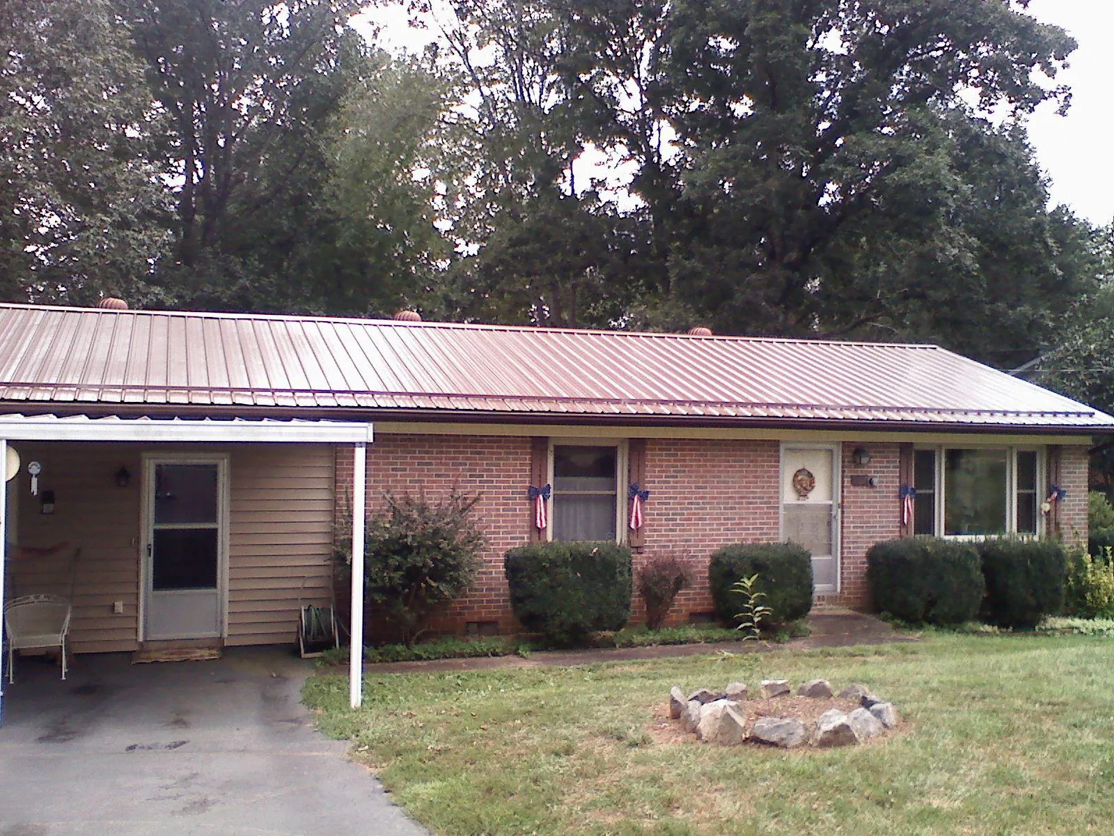 Bronze metal roof and carport on a brick ranch home — Roof Repair work by our crew in Refton